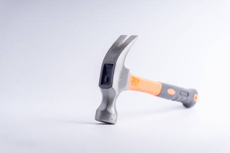 Hammer closeup on white background with selective focus and crop fragmentの写真素材