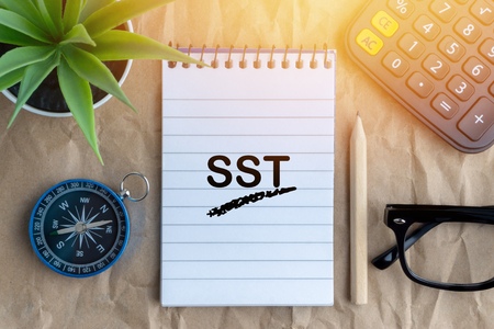 Notepad, flower vase, spectacle, pencil , calculator, compass and words SST on wooden paper background. Business and education conceptの写真素材