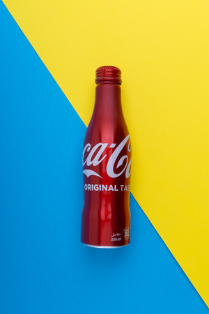 Kuala Lumpur, Malaysia - February, 13, 2019 : Coca Cola or coke drink on a blue and yellow background with selective focus. Coca Cola is a rival of Pepsiのeditorial素材