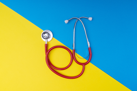 Stethoscope on blue and yellow background with selective focusの写真素材