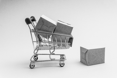 Shopping cart and box  on black and white background, business and shopping concept. Selective focusの写真素材