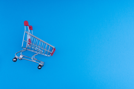 Shopping cart on blue background, business and shopping concept. Selective focusの写真素材