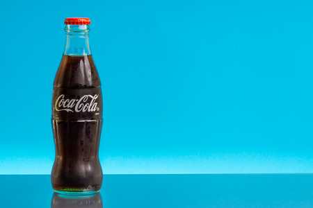 Kuala Lumpur, Malaysia - February 18,2019: Coca Cola drink on blue background. Selective focus and crop fragmentのeditorial素材
