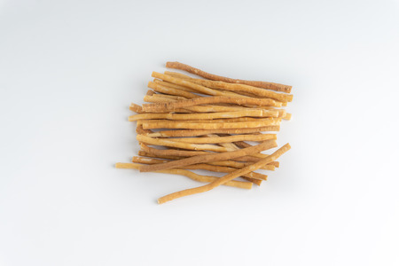 Natural toothbrush Miswak (Kayu Sugi) on white background with selective focus and crop fragment. It...