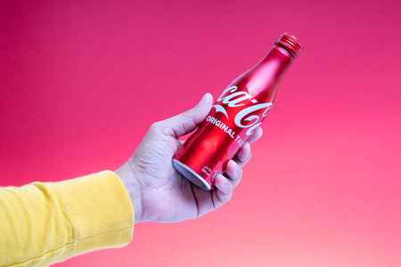 Kuala Lumpur, Malaysia - February, 13, 2019 : Coca Cola or Coke drink on red background with selective focus. Coca Cola is a rival of Pepsiのeditorial素材