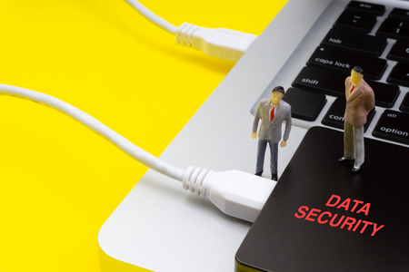 DATA SECURITY inscription written words, laptop, hard drive and businessman miniature. Business and technology conceptの写真素材