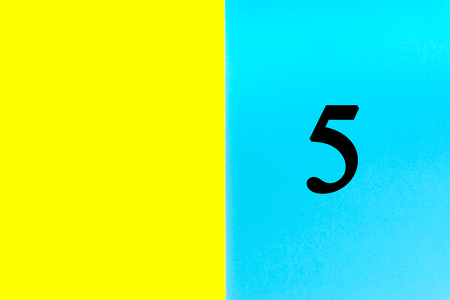 FIVE or 5 written words on blue and yellow background. Number, Calendar, Month, Date and Copy Space conceptの写真素材