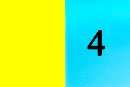 FOUR or 4 written words on blue and yellow background. Number, Calendar, Month, Date and Copy Space conceptの写真素材