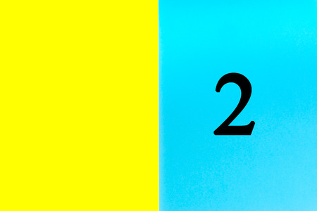 TWO or 2 written words on blue and yellow background. Number, Calendar, Month, Date and Copy Space conceptの写真素材
