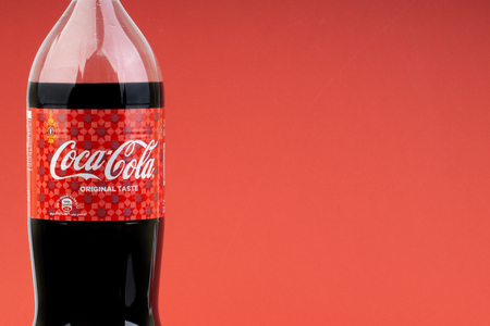 Kuala Lumpur, Malaysia - March 18,2019: Coca Cola Lantern edition bottle drink over a red  background with selective focus and crop fragment.のeditorial素材