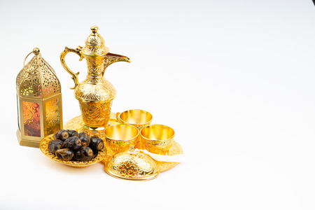 Premium dates, lantern and arabic coffee set on white background. Selective focus, copy space and Ramadan Kareem conceptの写真素材