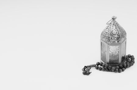 Lantern and rosary beads or tasbih on black and white. Selective focus, copy space and Ramadan Kareem conceptの写真素材
