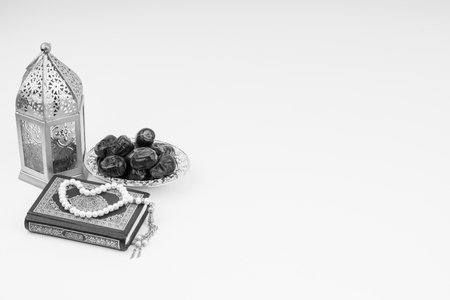Lantern, Dates, Koran and Rosary on white background with selective focus and crop fragment. Ramadan, Religion and Copy space concept. Black and White conceptの写真素材