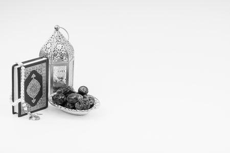 Lantern, Dates, Koran and Rosary on white background with selective focus and crop fragment. Ramadan, Religion and Copy space concept. Black and White conceptの写真素材