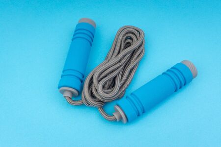 Skipping rope or jumping rope isolated on blue background. Selective focus and crop fragmentの写真素材
