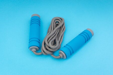 Skipping rope or jumping rope isolated on blue background. Selective focus and crop fragmentの写真素材