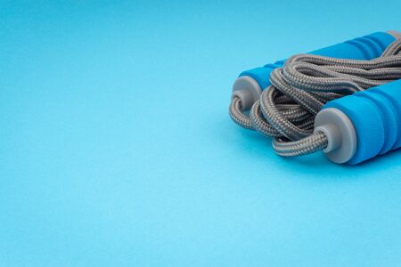 Skipping rope or jumping rope isolated on blue background. Selective focus and crop fragmentの写真素材