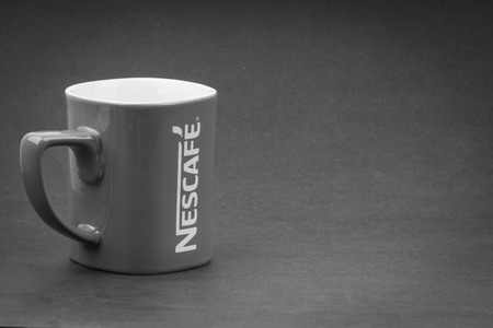 Kuala Lumpur, Malaysia - July 03, 2019; Promotional red Nescafe mug on Black and White.  Selective focusのeditorial素材