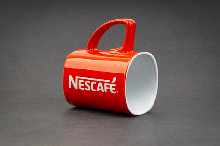 Kuala Lumpur, Malaysia - July 03, 2019; Promotional red Nescafe mug on dark background. Selective focusのeditorial素材
