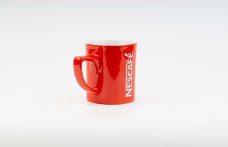 Kuala Lumpur, Malaysia - July 03, 2019:  Promotional red Nescafe mug on white background. Selective focusのeditorial素材