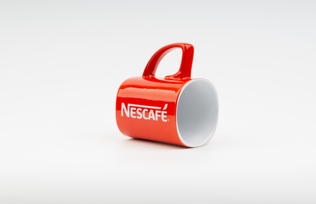 Kuala Lumpur, Malaysia - July 03, 2019:  Promotional red Nescafe mug on white background. Selective focusのeditorial素材