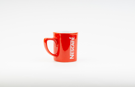 Kuala Lumpur, Malaysia - July 03, 2019:  Promotional red Nescafe mug on white background. Selective focusのeditorial素材