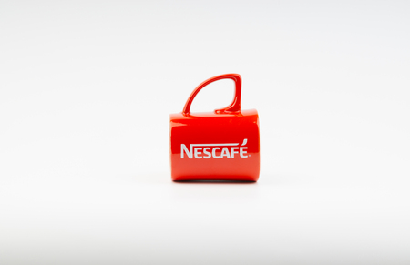 Kuala Lumpur, Malaysia - July 03, 2019:  Promotional red Nescafe mug on white background. Selective focusのeditorial素材