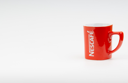 Kuala Lumpur, Malaysia - July 03, 2019:  Promotional red Nescafe mug on white background. Selective focusのeditorial素材