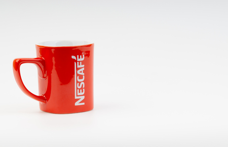 Kuala Lumpur, Malaysia - July 03, 2019:  Promotional red Nescafe mug on white background. Selective focusのeditorial素材
