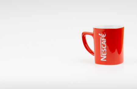 Kuala Lumpur, Malaysia - July 03, 2019:  Promotional red Nescafe mug on white background. Selective focusのeditorial素材