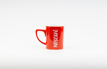 Kuala Lumpur, Malaysia - July 03, 2019:  Promotional red Nescafe mug on white background. Selective focusのeditorial素材