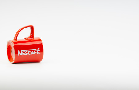 Kuala Lumpur, Malaysia - July 03, 2019:  Promotional red Nescafe mug on white background. Selective focusのeditorial素材