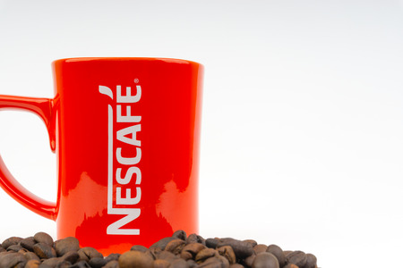 Kuala Lumpur, Malaysia - July 03, 2019:  Promotional red Nescafe mug on white background. Selective focusのeditorial素材