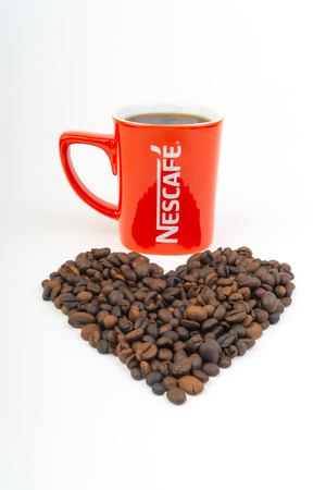 Kuala Lumpur, Malaysia - July 03, 2019:  Promotional red Nescafe mug on white background. Selective focusのeditorial素材