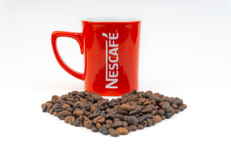Kuala Lumpur, Malaysia - July 03, 2019:  Promotional red Nescafe mug on white background. Selective focusのeditorial素材