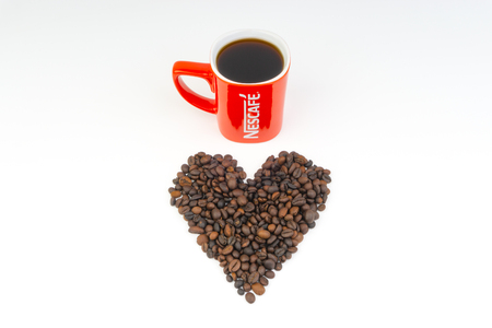 Kuala Lumpur, Malaysia - July 03, 2019:  Promotional red Nescafe mug on white background. Selective focusのeditorial素材