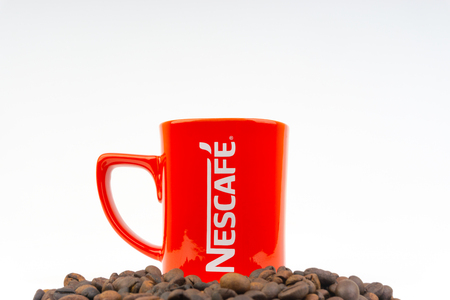 Kuala Lumpur, Malaysia - July 03, 2019:  Promotional red Nescafe mug on white background. Selective focusのeditorial素材