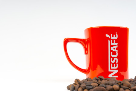 Kuala Lumpur, Malaysia - July 03, 2019:  Promotional red Nescafe mug on white background. Selective focusのeditorial素材
