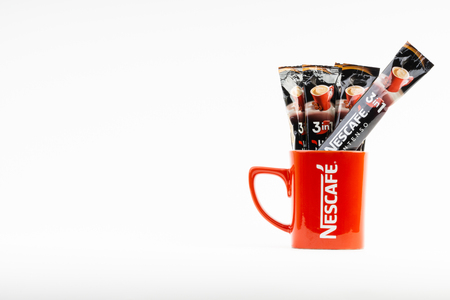 Kuala Lumpur, Malaysia - July 2, 2019: Sachet of instant Intenso Nescafe coffee with Nescafe mug on white background. Selective focusのeditorial素材