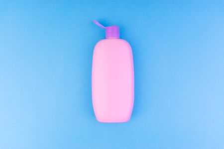 Flat lay composition of baby care products on a blue background. View from above shampoo or shower bottle gelの写真素材