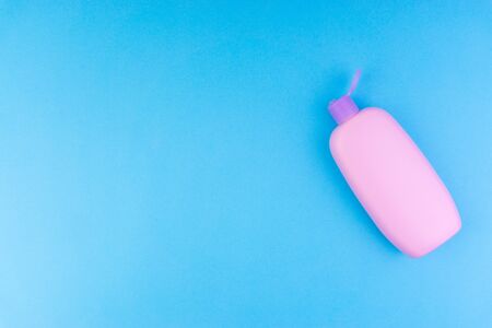 Flat lay composition of baby care products on a blue background. View from above shampoo or shower bottle gelの写真素材