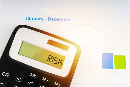 A calculator with the word RISK on the display. Selective focus and crop fragmentの写真素材