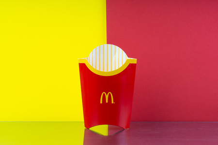 Kuala Lumpur, Malaysia - July 29, 2019: Mc Donald empty fries box on yellow and red backgroundのeditorial素材