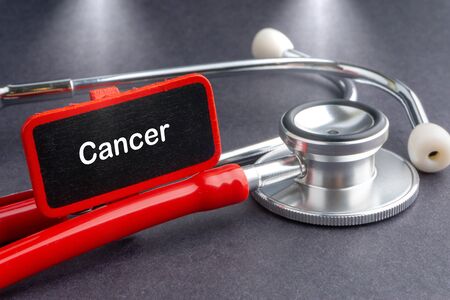 CANCER. Medicine concept. Blackboard with word CANCER and stethoscope