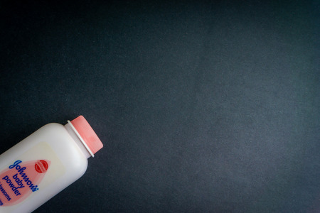 KUALA LUMPUR, MALAYSIA- November 9, 2019: Bottle of Johnson & Johnson baby powder on black background. Johnson & Johnson talc. Selective focusのeditorial素材