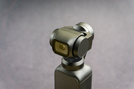 KUALA LUMPUR, MALAYSIA - November 13, 2019 : DJI Osmo Pocket stabilized handheld camera close up on black background. Selective focus and crop fragmentのeditorial素材