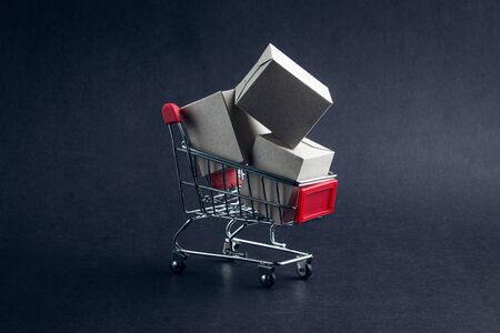 Shopping cart and box on dark background, business, shopping concept. Selective focusの写真素材
