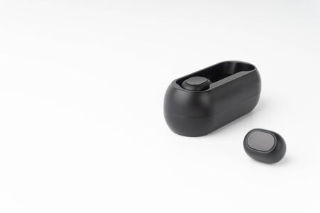 Wireless earbuds or earphones on white background. Copy space and technology conceptの写真素材