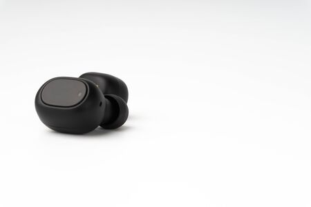 Wireless earbuds or earphones on white background. Copy space and technology conceptの写真素材