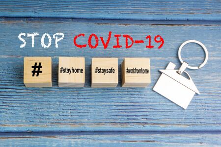 Concept image a wooden block and word - #WFH ( WORK FROM HOME, STAY HOME and STAY SAFE on wooden background. Coronavirus and Covid19 Conceptの写真素材